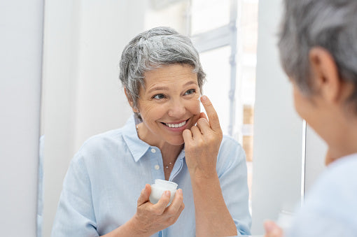 A confident woman in her fifties enjoying her morning coffee